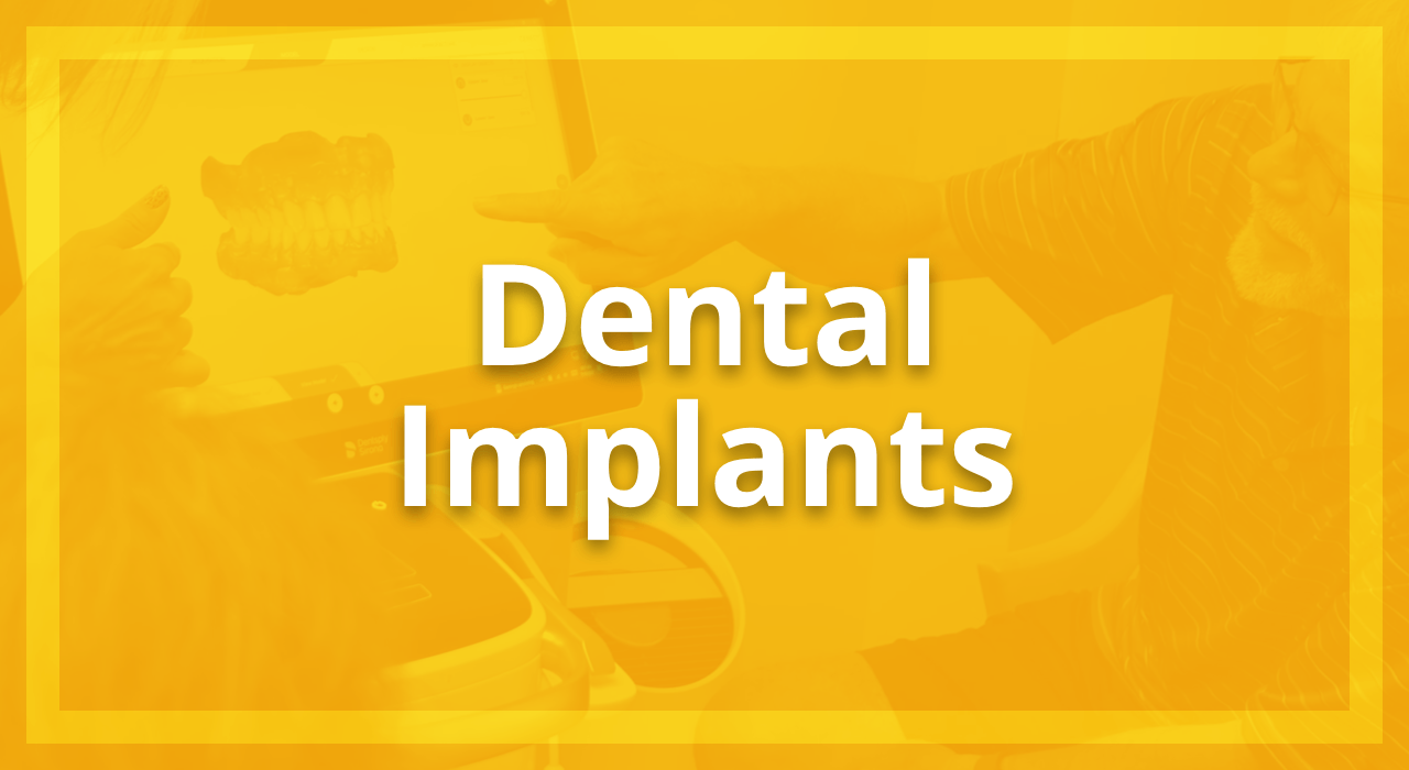 Dental Implants at Dupont Family Dentistry. Yellow overlay on image of Dupont Family Dentistry dental hygienist and patient looking at teeth on computer. Learn more.